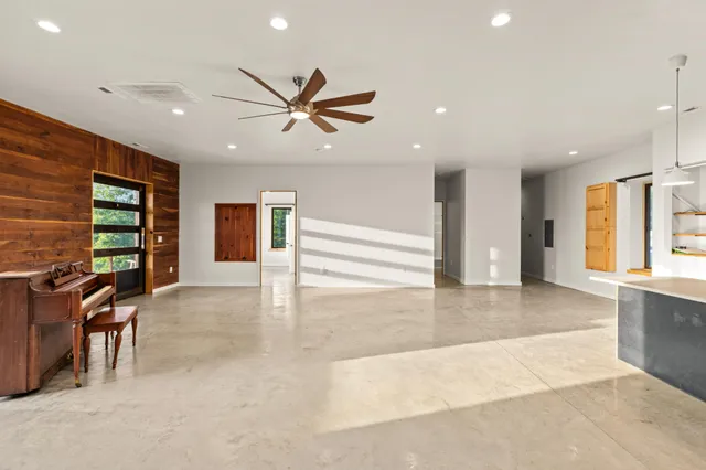 a bathroom with a granite countertop toilet and a shower