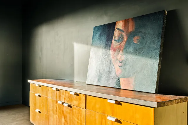 an empty room with a window and a ceiling fan