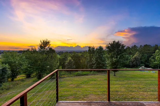 a view of a back yard of the house and green space