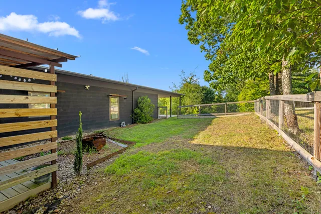 a view of a patio with a table chairs and a backyard