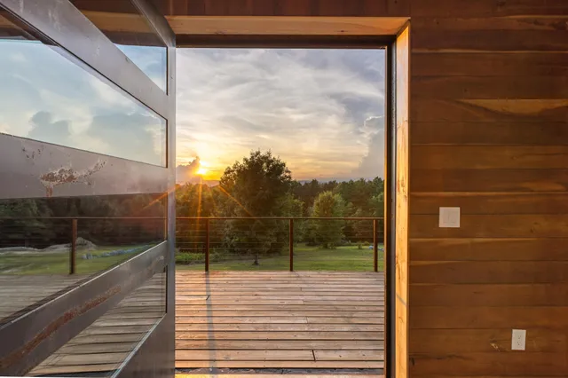 a view of a wooden deck and a big yard