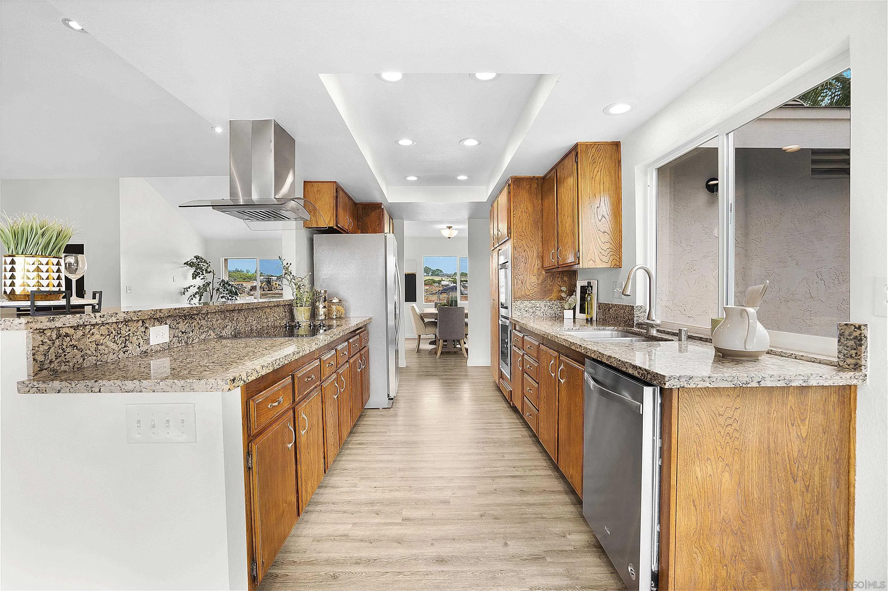 1138 Sidonia Street Encinitas, CA 92024 - Photo 8 of 17 a large kitchen with stainless steel appliances kitchen island granite countertop a large counter top and a stove
