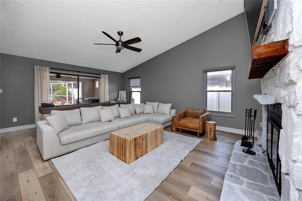 27 Summit Lane Safety Harbor, FL 34695 - Photo 12 of 48 a living room with furniture and a fireplace