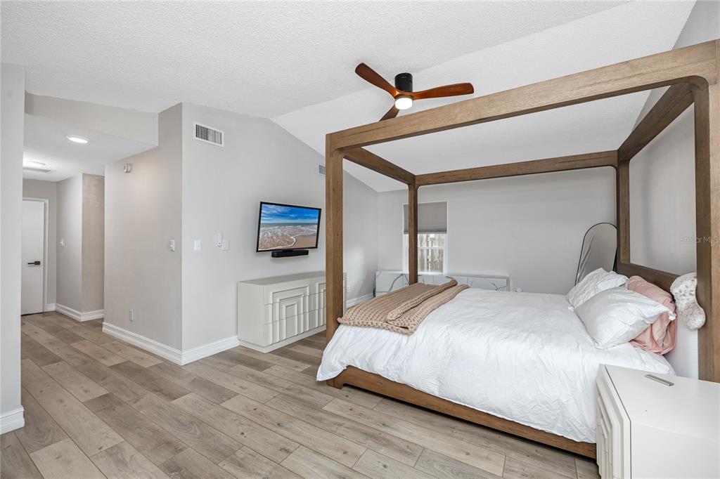 27 Summit Lane Safety Harbor, FL 34695 - Photo 15 of 48 a bedroom with a bed and a tv