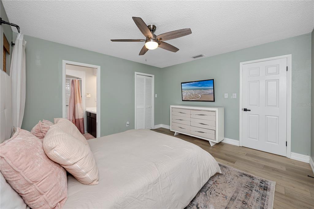27 Summit Lane Safety Harbor, FL 34695 - Photo 20 of 48 a bedroom with a bed and a ceiling fan