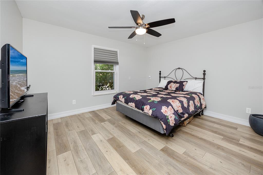 27 Summit Lane Safety Harbor, FL 34695 - Photo 24 of 48 a bedroom with a bed window and a flat screen tv