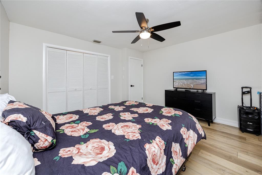 27 Summit Lane Safety Harbor, FL 34695 - Photo 25 of 48 a bedroom with a bed and a chandelier