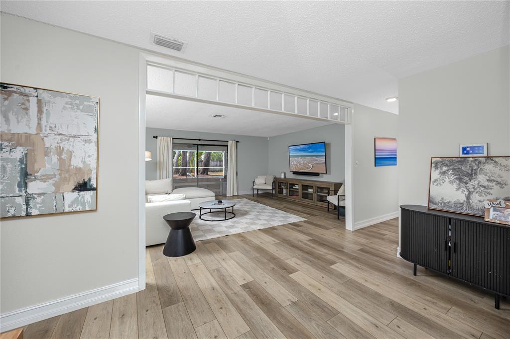 27 Summit Lane Safety Harbor, FL 34695 - Photo 3 of 48 a living room with furniture and a flat screen tv
