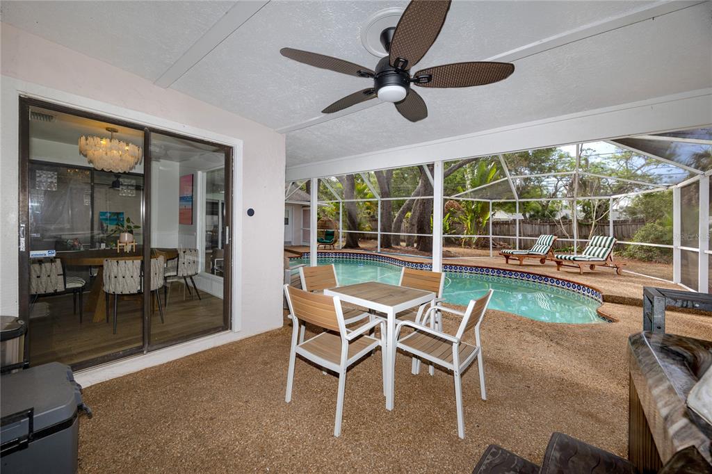 27 Summit Lane Safety Harbor, FL 34695 - Photo 31 of 48 a dining room with furniture a chandelier and a floor to ceiling window