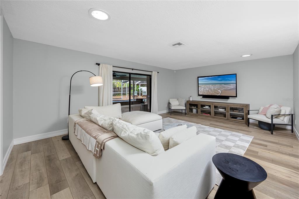 27 Summit Lane Safety Harbor, FL 34695 - Photo 6 of 48 a living room with furniture and a flat screen tv