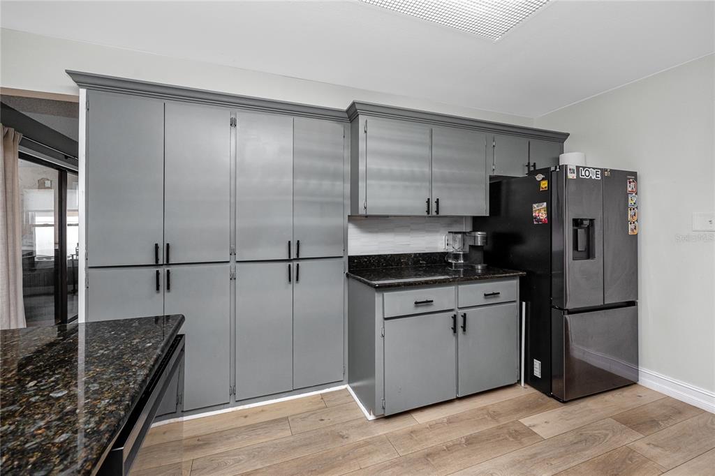 27 Summit Lane Safety Harbor, FL 34695 - Photo 8 of 48 a kitchen with granite countertop a refrigerator and a sink
