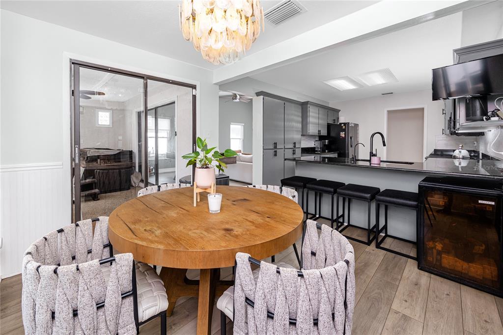27 Summit Lane Safety Harbor, FL 34695 - Photo 10 of 48 a dining room with furniture a chandelier and wooden floor