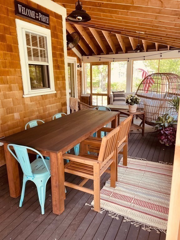 802 State Road Plymouth, MA 02360 - Photo 13 of 42 a view of a patio with table and chairs with wooden floor and fence