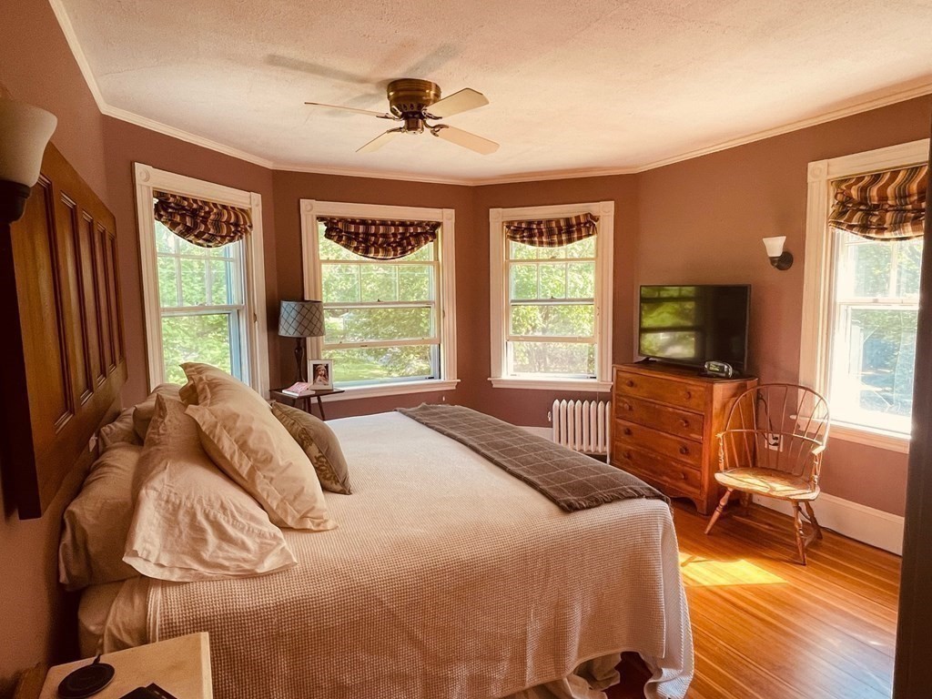 802 State Road Plymouth, MA 02360 - Photo 20 of 42 a bedroom with a bed and large windows