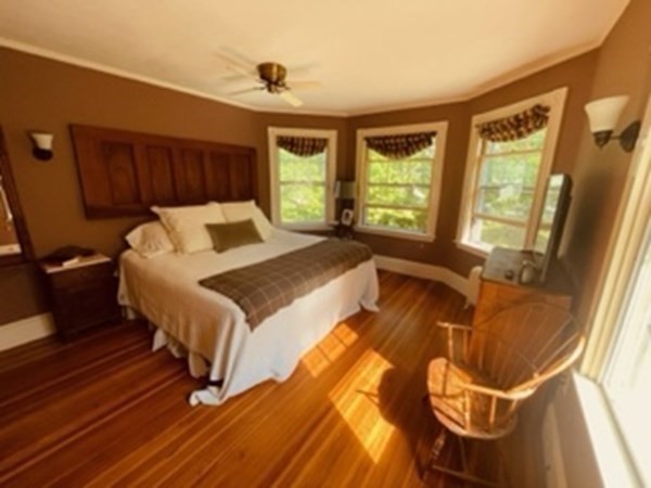 802 State Road Plymouth, MA 02360 - Photo 22 of 42 a bed sitting in a bedroom next to a window