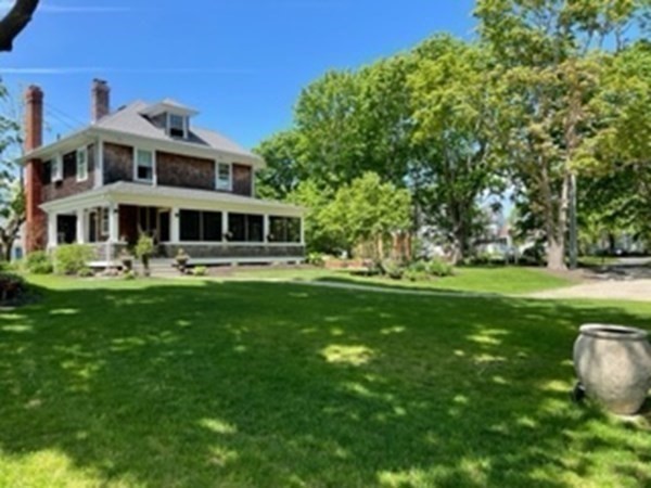 802 State Road Plymouth, MA 02360 - Photo 32 of 42 a front view of a house with a yard table and chairs