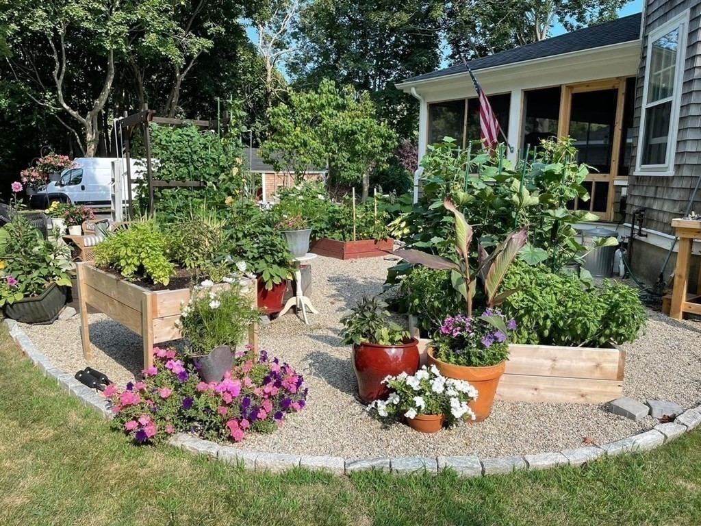 802 State Road Plymouth, MA 02360 - Photo 34 of 42 a view of a wooden house with a yard and potted plants