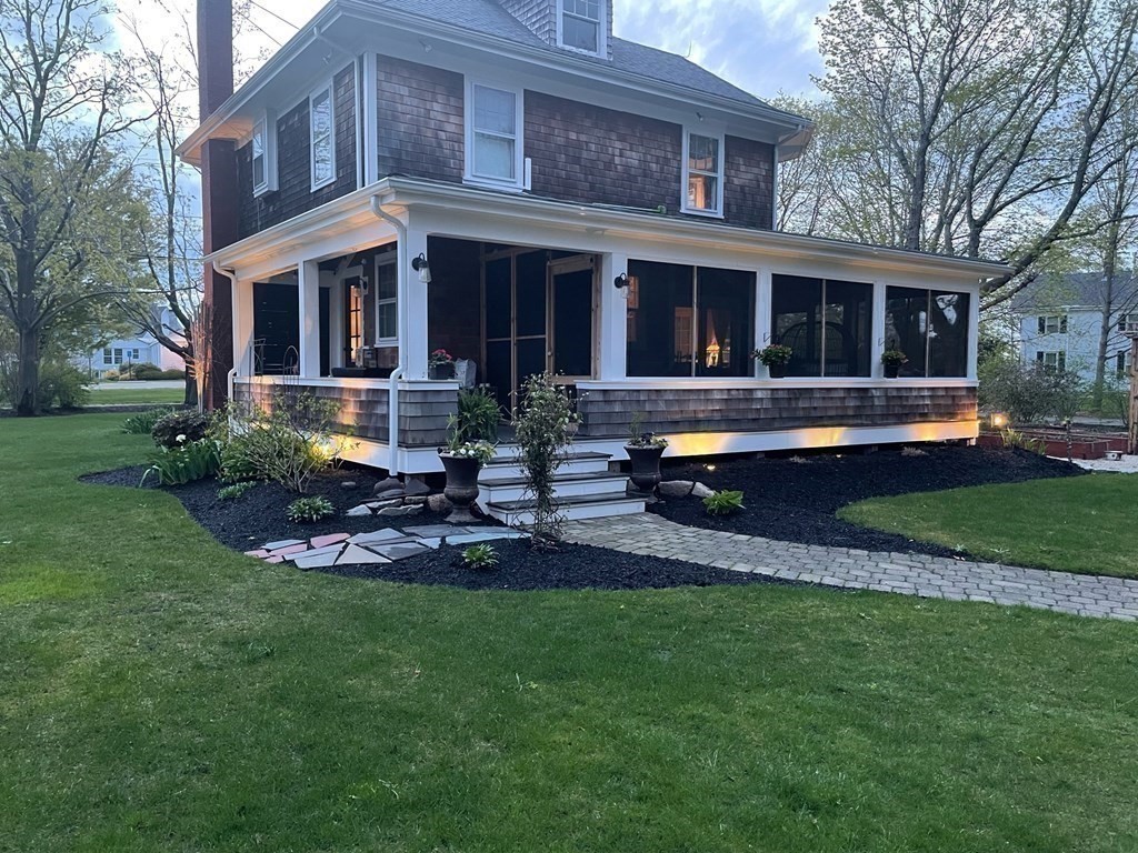802 State Road Plymouth, MA 02360 - Photo 38 of 42 a front view of a house with a yard table and chairs