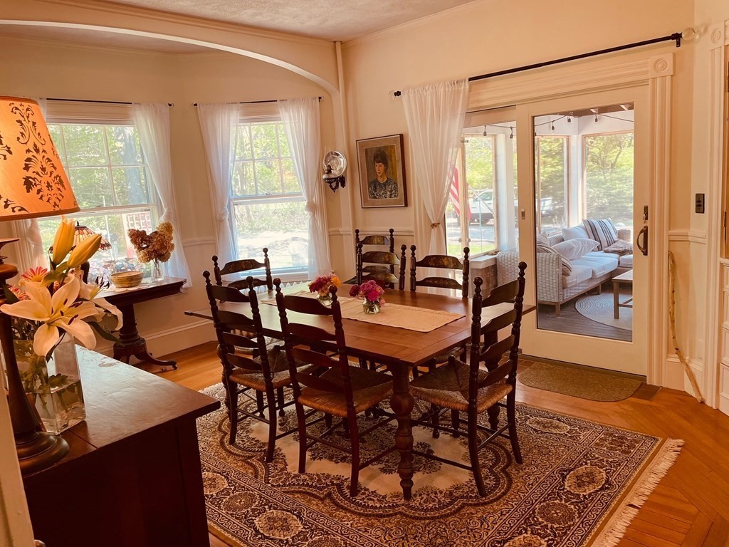 802 State Road Plymouth, MA 02360 - Photo 10 of 42 a dining room with furniture a chandelier and wooden floor