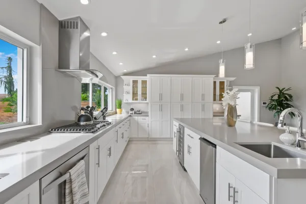 a kitchen with stainless steel appliances granite countertop a stove and a sink