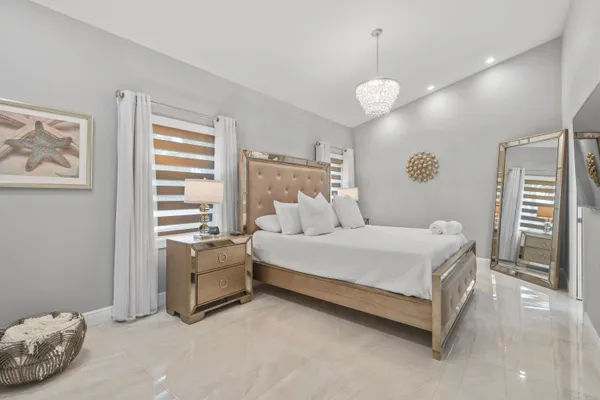 a bedroom with a bed and a television