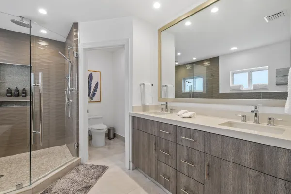 a white bath tub sitting next to a shower
