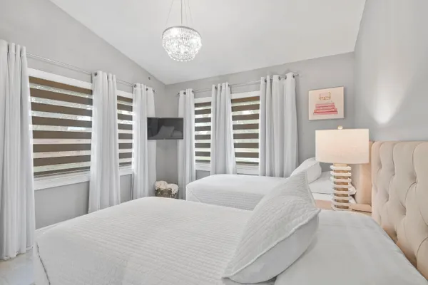 a bedroom with two beds and a window