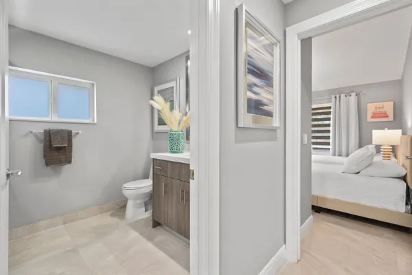 a bathroom with a sink a toilet and mirror