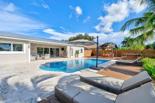 a view of a patio with a table and chairs
