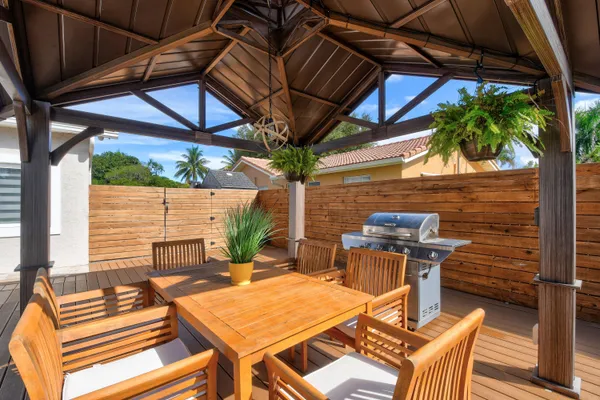 a view of a backyard with a garden and entertaining space