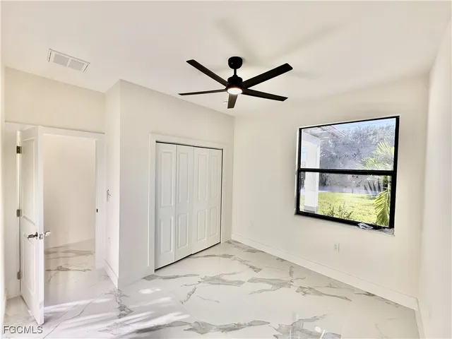 a view of a livingroom with a window and a ceiling fan