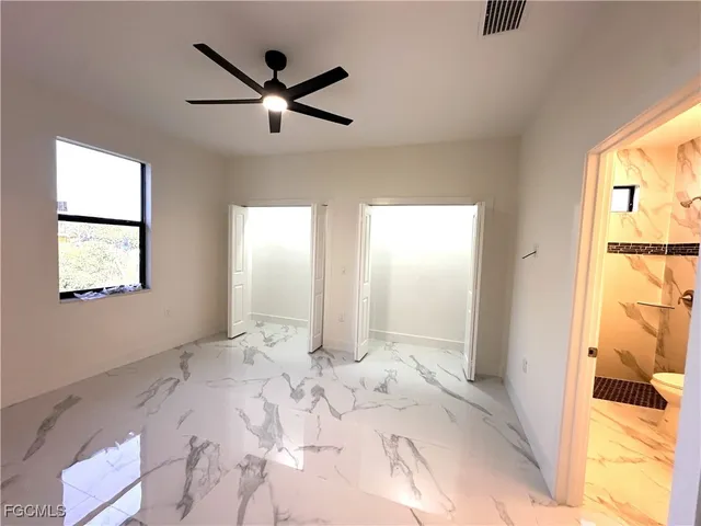 a view of a big room with windows and cabinet