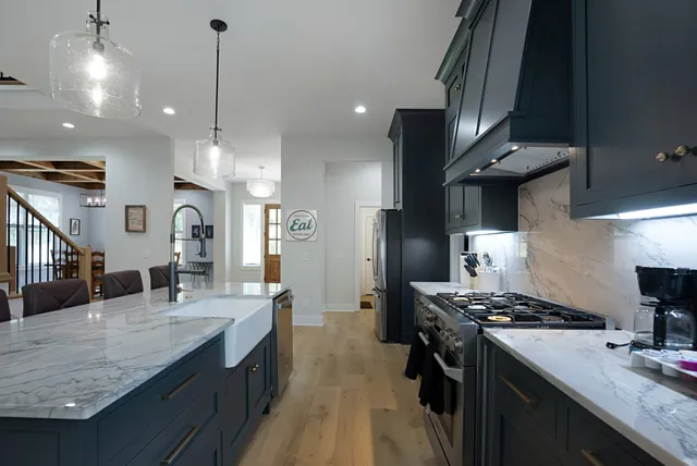 a kitchen with stainless steel appliances kitchen island a large stove a sink dishwasher and a refrigerator