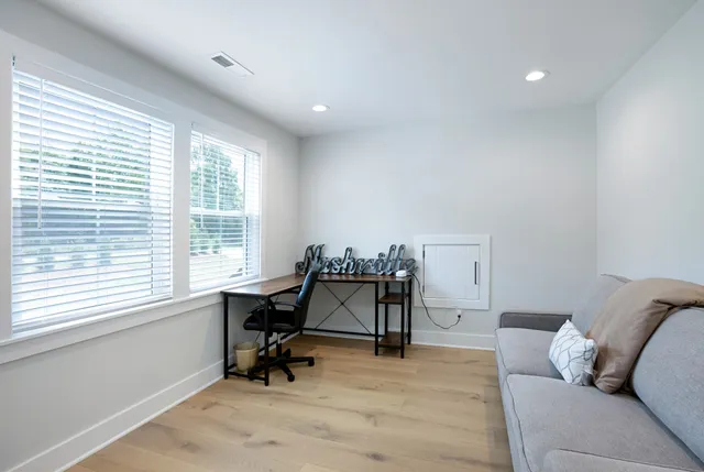 a view of workspace with furniture and windows