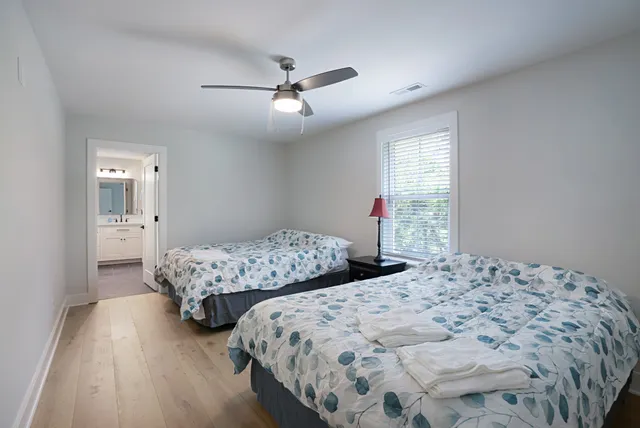 a bedroom with two beds and a chandelier