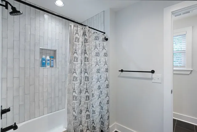 a bathroom with a shower curtain and a bathtub