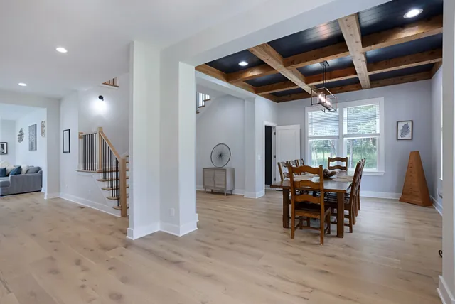 a view of a livingroom with furniture and a refrigerator