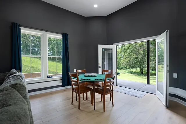 a dining room with furniture window and wooden floor