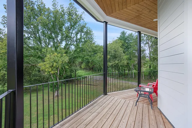 a balcony with wooden floor