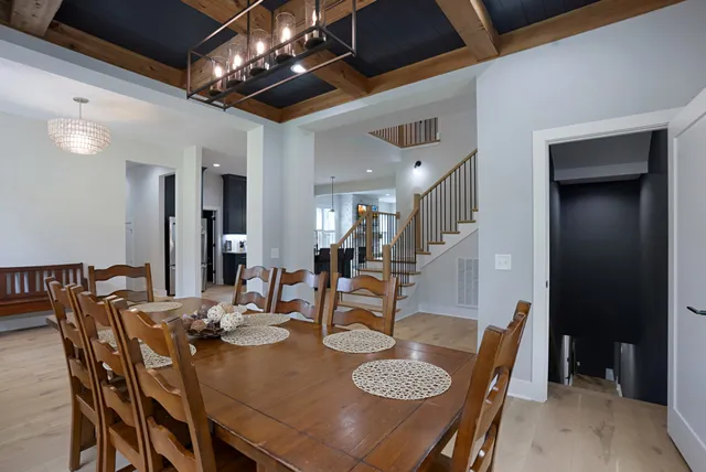 a view of a dining room with furniture and a chandelier