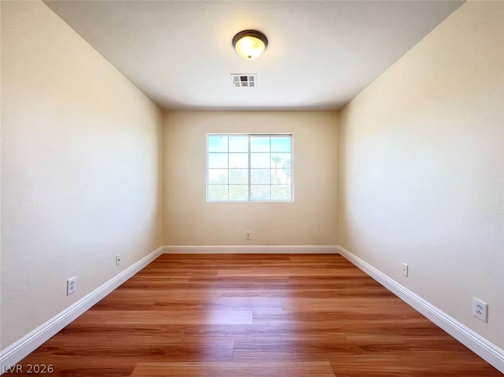 9891 Ridge Hill Avenue Las Vegas, NV 89147 - Photo 24 of 29 Well-lit and functional, this versatile space features durable wood flooring and ample natural illumination.