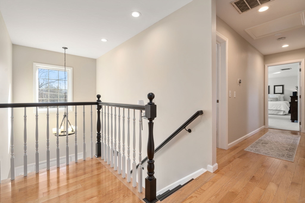12 Silvermine Road Woburn, MA 01801 - Photo 20 of 36 a view of a hallway with wooden floor and stairs