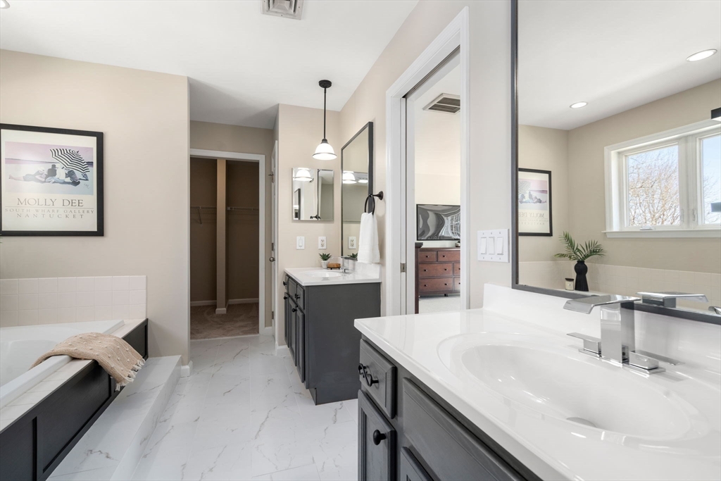 12 Silvermine Road Woburn, MA 01801 - Photo 23 of 36 a bathroom with a tub sink and mirror
