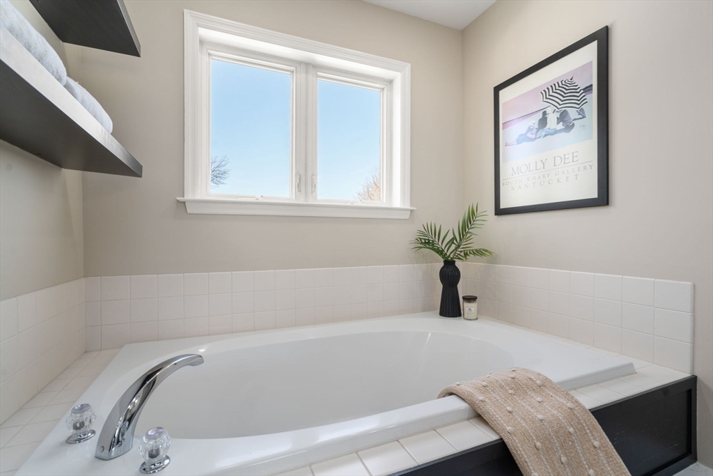 12 Silvermine Road Woburn, MA 01801 - Photo 24 of 36 a white bath tub sitting in a bathroom