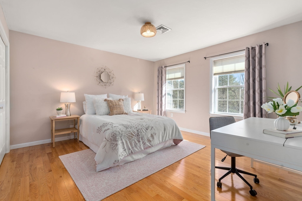 12 Silvermine Road Woburn, MA 01801 - Photo 27 of 36 a bedroom with a bed and wooden floor