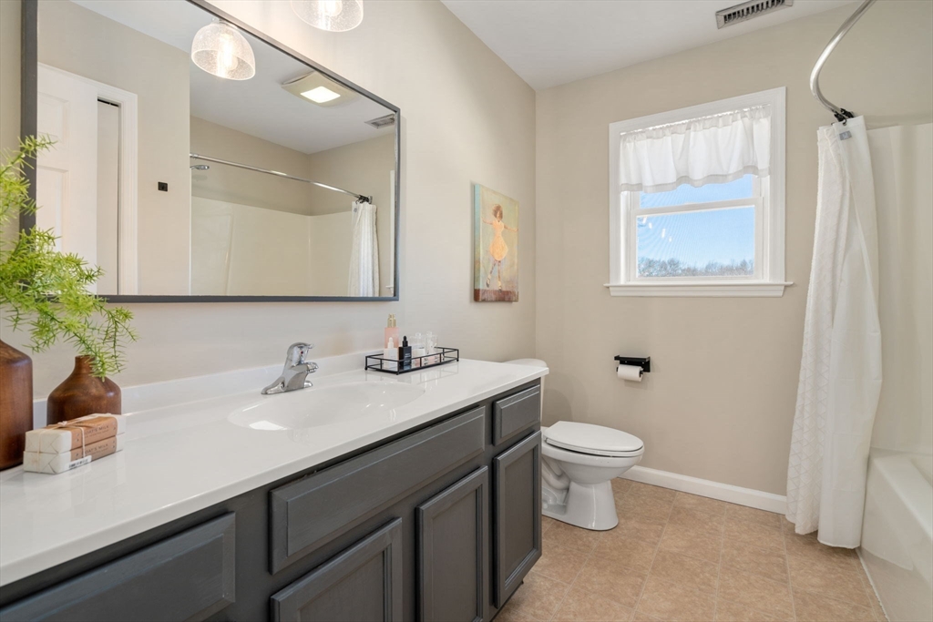12 Silvermine Road Woburn, MA 01801 - Photo 28 of 36 a bathroom with a sink toilet and a mirror