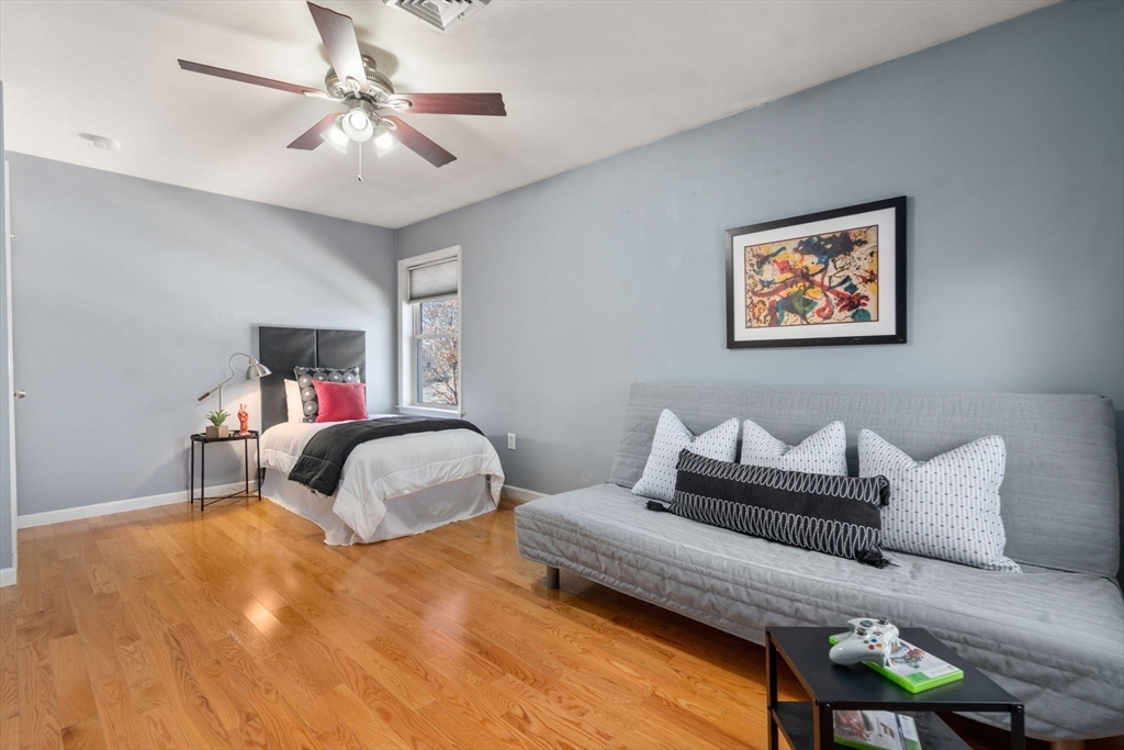 12 Silvermine Road Woburn, MA 01801 - Photo 29 of 36 a bedroom with furniture and a chandelier
