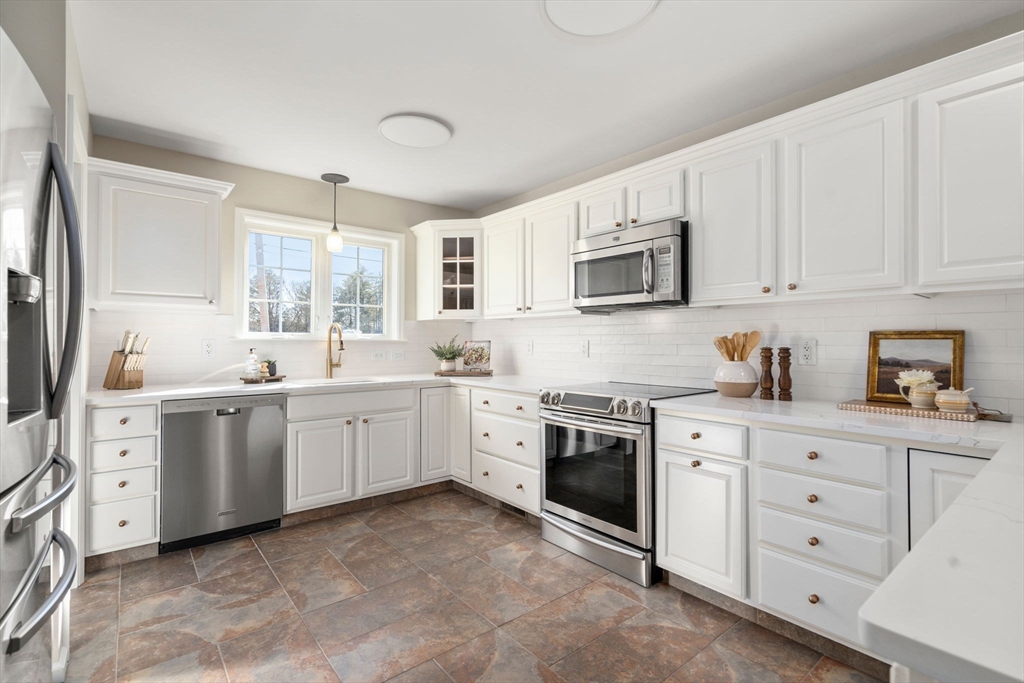 12 Silvermine Road Woburn, MA 01801 - Photo 7 of 36 a kitchen with white cabinets sink and appliances