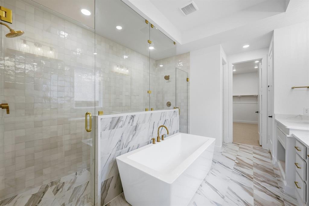 571 Twilight Drive Prosper, TX 75078 - Photo 13 of 30 a spacious bathroom with a shower a sink and a bathtub