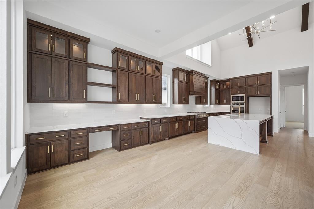 571 Twilight Drive Prosper, TX 75078 - Photo 20 of 30 a large white kitchen with stainless steel appliances